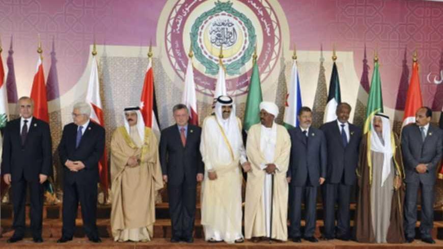 Heads of Arab states gather ahead of a group photo during the opening of the Arab League summit in Doha March 26, 2013. Russia criticised the Arab League on Wednesday for giving a seat formerly held by the Syrian government to a representative of the Syrian opposition at a summit in Doha. Picture taken March 26, 2013. REUTERS/Egyptian Presidency/Handout (EGYPT - Tags: POLITICS) ATTENTION EDITORS - THIS IMAGE WAS PROVIDED BY A THIRD PARTY. FOR  EDITORIAL USE ONLY. NOT FOR SALE FOR MARKETING OR ADVERTISING CA