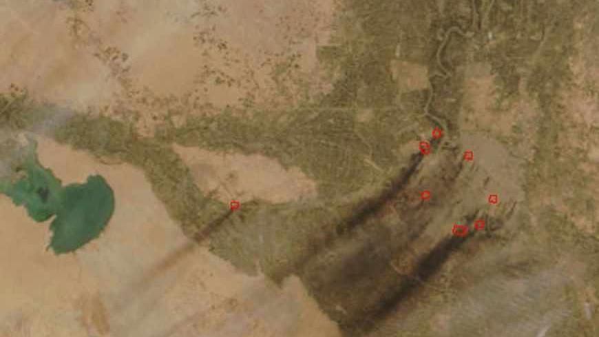 IN SPACE - MARCH 31:  This portion of a NASA handout satellite image of Baghdad, Iraq shows black smoke emanating from "hot spots" circled in red March 31, 2003. According to NASA the black plumes of smoke and there associated thermal anomalies or "hot spots," indicate that they are possibly oil fires. (Photo by NASA/MODIS/Getty Images)