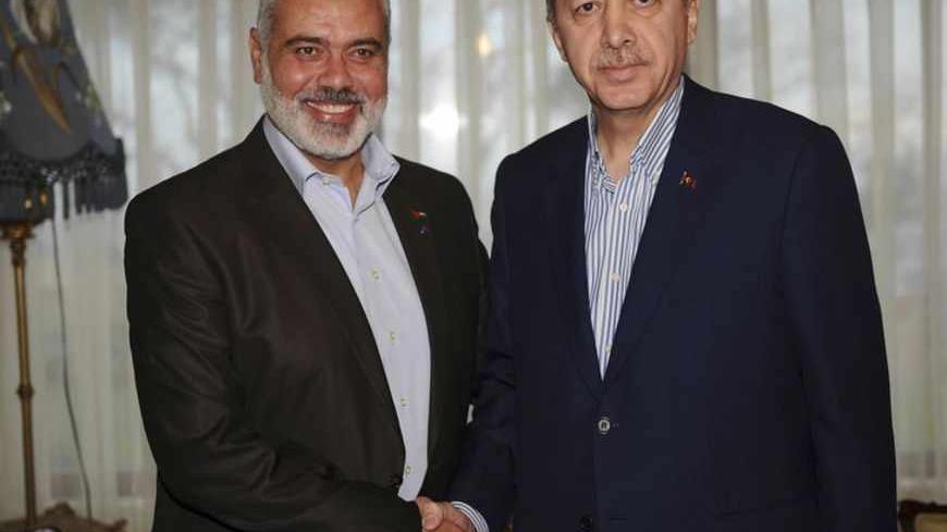 Turkey's Prime Minister Recep Tayyip Erdogan (R) and Hamas' Gaza leader Ismail Haniyeh pose before a meeting in Istanbul January 1, 2012.  REUTERS/Kayhan Ozer/Prime Minister's Press Office/Handout (TURKEY - Tags: POLITICS) FOR EDITORIAL USE ONLY. NOT FOR SALE FOR MARKETING OR ADVERTISING CAMPAIGNS. THIS IMAGE HAS BEEN SUPPLIED BY A THIRD PARTY. IT IS DISTRIBUTED, EXACTLY AS RECEIVED BY REUTERS, AS A SERVICE TO CLIENTS - RTR2VSJY
