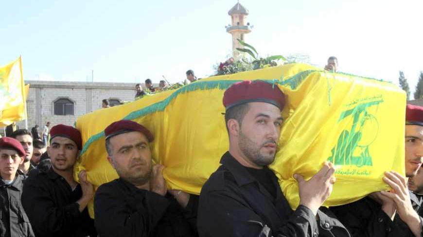 Lebanon's Hezbollah members carry the coffin of a Hezbollah member during his funeral in Ansar village near  Baalbek city October 8, 2012. Hezbollah gave no details about their deaths but sources in Baalbek said they and another Hezbollah man were killed near a Syrian border town where rebels are fighting Assad's forces. REUTERS/Ahmed Shalha    (LEBANON - Tags: CIVIL UNREST POLITICS) - RTR38X93