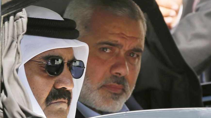 Hamas Prime Minister Ismail Haniyeh (R) and the Emir of Qatar Sheikh Hamad bin Khalifa al-Thani arrive at a cornerstone laying ceremony for Hamad, a new residential neighbourhood in Khan Younis in the southern Gaza Strip October 23, 2012. The Emir of Qatar embraced the Hamas leadership of Gaza on Tuesday with an official visit breaking the isolation of the militant Palestinian Islamist movement, to the dismay of Israel and rival, Western-backed Palestinian leaders in the West Bank. REUTERS/Mohammed Salem (G