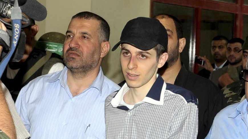 Hamas mediator Ahmed Al-Jaabari (L) escorts Israeli soldier Gilad Shalit on the Egyptian side of the Rafah border crossing in this October 18, 2011 file photo. Israel killed  Jaabari, the military commander of the Islamist group Hamas, in a missile strike on the Gaza Strip on November 14, 2012 and launched air raids across the enclave, pushing the two sides to the brink of a new war.  REUTERS/Middle East News Agency (MENA)/Khalid Farid/File       (EGYPT - Tags: POLITICS CIVIL UNREST)  FOR EDITORIAL USE ONLY