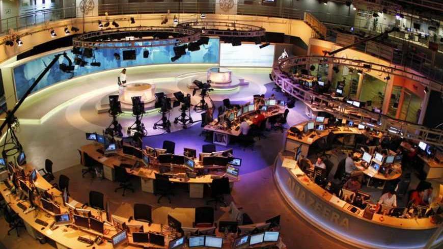 A general view shows the newsroom at the headquarters of the Qatar-based Al Jazeera English-language channel in Doha February 7, 2011. As much as CNN capitalized on its coverage of the 1990-91 Gulf War, Al Jazeera English has won praise for its on-the-spot reporting and context about the Egyptian protests. It will be talking to U.S. cable operators about deals "in the coming days and weeks," Al Anstey, managing director of Al Jazeera's English-language service said in a telephone interview from Qatar. REUTE
