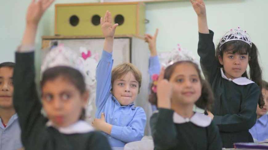 Palestinian school children raise their hands during a class in al-Qahera elementary school in Gaza City April 2, 2013. New rules from the Education Ministry of the Islamist Hamas movement ruling the Gaza Strip will bar men from teaching at girls' schools and mandate separate classes for boys and girls from the age of nine.
REUTERS/Mohammed Salem (GAZA - Tags: POLITICS EDUCATION) - RTXY5M6