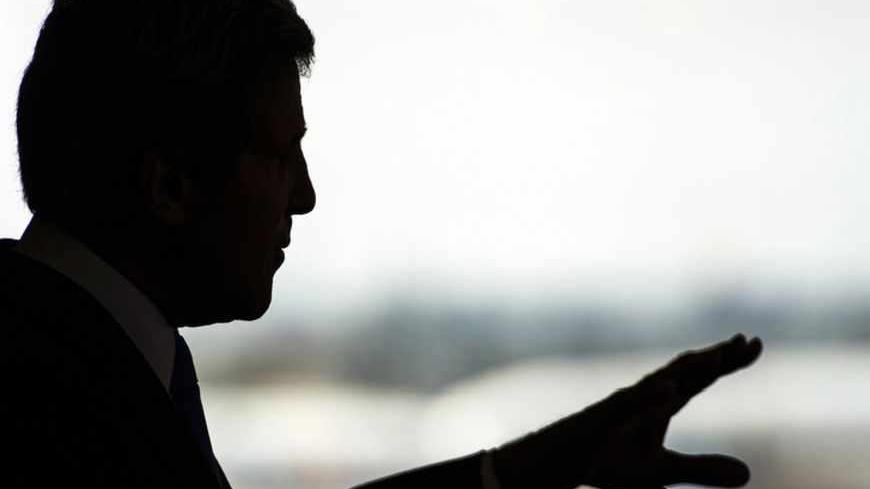 U.S. Secretary of State John Kerry is silhouetted during a news conference at Ben Gurion International Airport near Tel Aviv April 9, 2013. Kerry said on Tuesday he had agreed to work with Israeli and Palestinian leaders to boost economic growth in the occupied West Bank as he seeks ways to revive Middle East peace talks. REUTERS/Paul J. Richards/Pool (JERUSALEM - Tags: POLITICS) - RTXYEP9