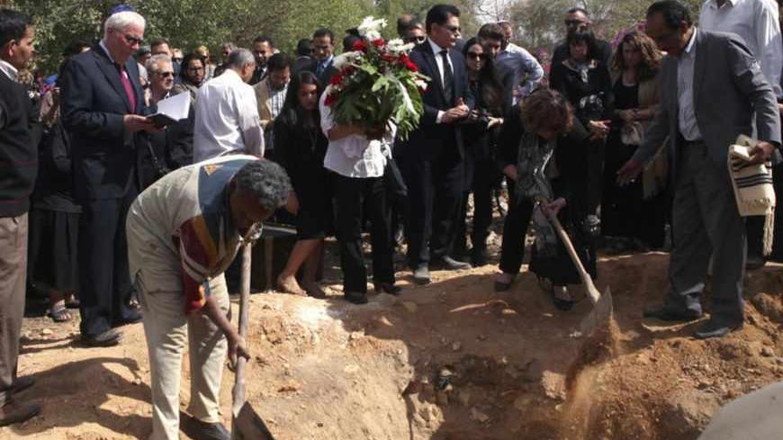 Diplomats from the United States and Israel are seen with other mourners as they bury veteran Jewish leader Carmen Weinstein, at the Bassatine Cemetery, Cairo's only active Jewish burial site, in Cairo, April 18, 2013. Weinstein, 82, died last Saturday at her home in Cairo where she was known over the past two decades for leading efforts to preserve the overwhelmingly Muslim country's Jewish heritage. REUTERS/Asmaa Waguih  (EGYPT - Tags: RELIGION POLITICS OBITUARY) - RTXYQYI