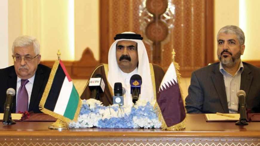 Qatari Emir Sheikh Hamad Bin Khalifa Al-Thani (C) Palestinian President Mahmoud Abbas (L) and Hamas leader Khaled Meshaal attend a ceremony in Doha, on February 6, 2012.  Abbas will head an interim national consensus government under a deal signed in Qatar between Abbas and Meshaal , ending a long-running disagreement that had stalled Palestinian reconciliation.AFP PHOTO/STR (Photo credit should read -/AFP/Getty Images)