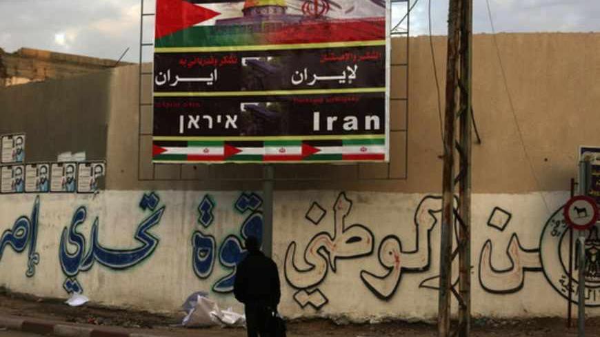 A Palestinian looks at a billboard thanking Iran in Gaza City on November 27, 2012.        AFP PHOTO / PATRICK BAZ        (Photo credit should read PATRICK BAZ/AFP/Getty Images)
