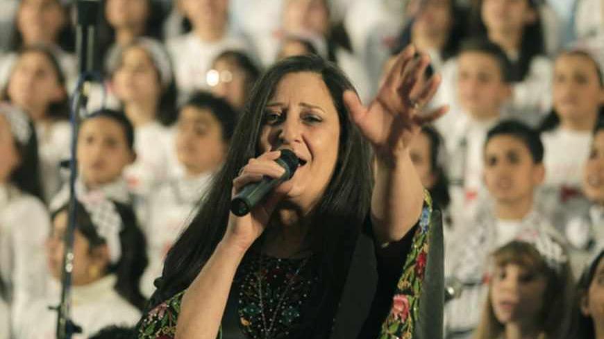 Palestinian singer Reem Talhami from the West Bank, sings with choir members, who attend an UNRWA (United Nations Relief and Works Agency for Palestine Refugees in the Near East) funded school,  during a performance of  the "al-Sununu" concert on April 23, 2013, in Gaza City. The Elena Rostropovich association, in cooperation with UNRWA are organizing the "al-Sununu" (The Swallow) concert which will involving a total of 23 choirs from across the Levant, including the Palestinian West Bank and Gaza Strip, Jo