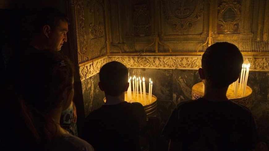 People light candles during a special prayer marking the anniversary of mass killings of Armenians in Ottoman Empire in 1915, in the Armenian Church in Jerusalem's Old City April 24, 2012. Armenia, backed by many historians and parliaments, says about 1.5 million Christian Armenians were killed in what is now eastern Turkey during World War One in a deliberate policy of genocide ordered by the Ottoman government. Successive Turkish governments and the vast majority of Turks feel the charge of genocide is an