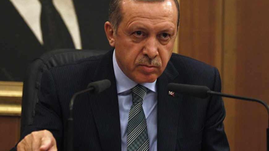 Turkey's Prime Minister Recep Tayyip Erdogan addresses the media before his flight to Denmark for an official visit at Esenboga Airport in Ankara March 19, 2013. REUTERS/Umit Bektas (TURKEY - Tags: POLITICS) - RTR3F72Q