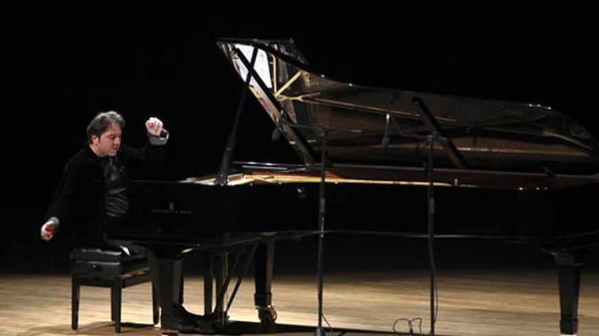 Turkish classical pianist Fazil Say performs during a concert in Ankara October 14, 2010. Internationally acclaimed Turkish classical pianist Fazil Say goes on trial on charges of insulting Muslim religious values in comments he posted on Twitter. REUTERS/Stringer (TURKEY - Tags: POLITICS CIVIL UNREST SOCIETY) - RTR399ZY