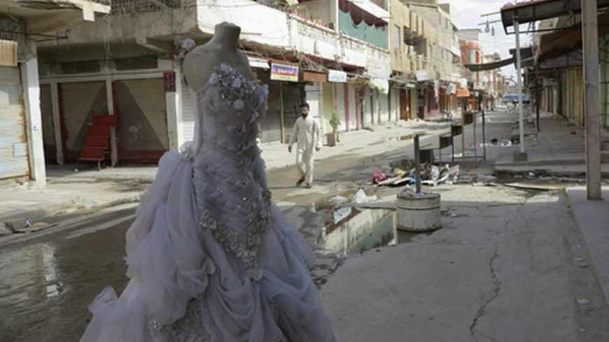 A man walks past a row of closed shops during a nationwide strike in Ramadi, 100 km (62 miles) west of Baghdad, April 22, 2013. Iraqis in Sunni provinces boycotted government offices, closed shops and deserted universities on Monday in the latest protests by the minority sect which fears it is being marginalised by Shi'ite Prime Minister Nuri al-Maliki.Streets in the Sunni-majority provinces of Anbar, Nineveh and Salahuddin were mostly empty after people shuttered their shops or stayed away from work in wha