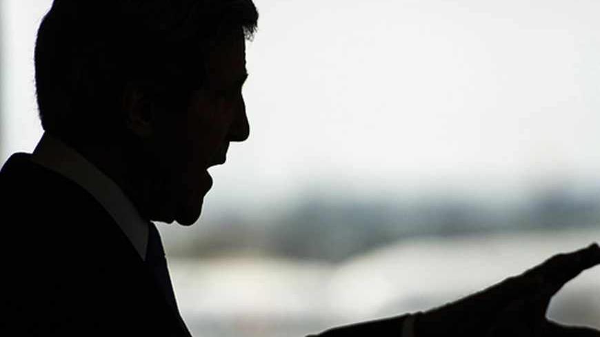 U.S. Secretary of State John Kerry is silhouetted during a news conference at Ben Gurion International Airport near Tel Aviv April 9, 2013. Kerry said on Tuesday he had agreed to work with Israeli and Palestinian leaders to boost economic growth in the occupied West Bank as he seeks ways to revive Middle East peace talks. REUTERS/Paul J. Richards/Pool (JERUSALEM - Tags: POLITICS) - RTXYER1