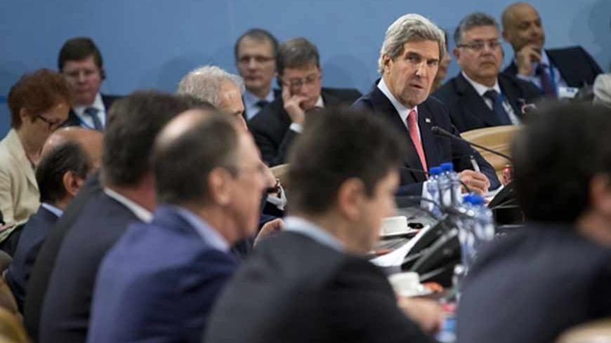 U.S. Secretary of State John Kerry looks towards Russian Foreign Minister Sergei Lavrov before the start of the NATO- Russia Council meeting at NATO headquarters in Brussels April 23, 2013. REUTERS/Evan Vucci/Pool (BELGIUM - Tags: POLITICS) - RTXYWOB
