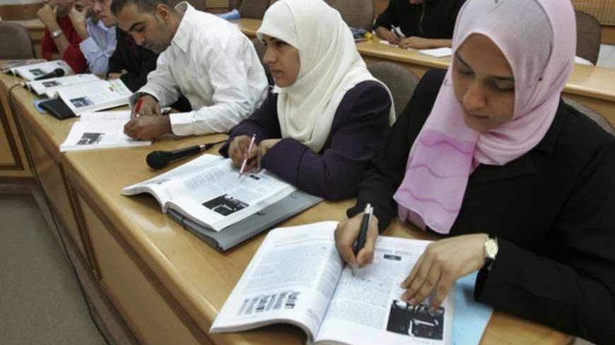 Palestinian students listen to lectures via a video conference link from Gaza's Al-Aqsa University November 1, 2006. Palestinian student Huda Abu El-Roos enrolled at Bethlehem University in the occupied West Bank in 2003. But Abu El-Roos, who lives in the Gaza Strip, has never set foot inside the campus. Citing security reasons, Israel has prohibited the 21-year-old and nine colleagues from attending classes on occupational therapy in the biblical town. Instead, the students listen to lectures via a video c