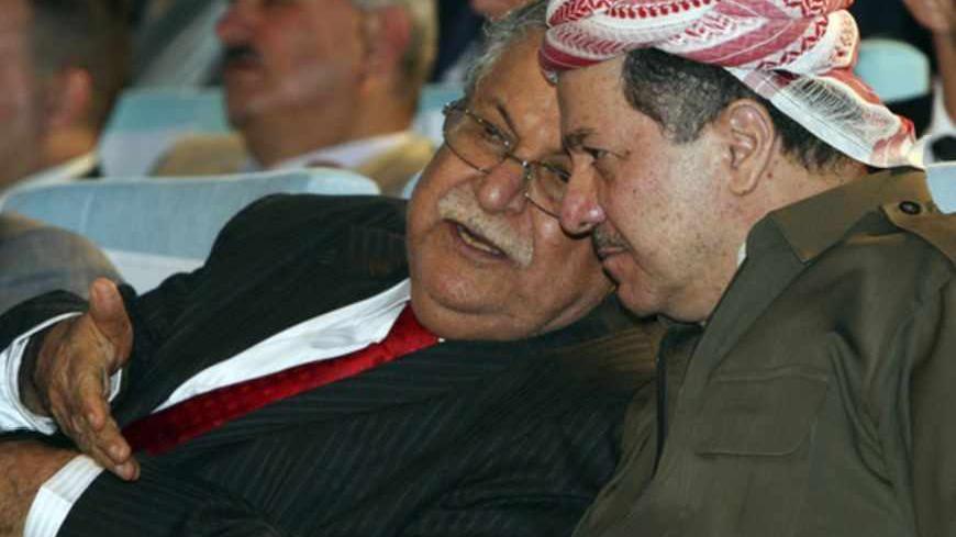 Kurdish President Massoud Barzani (R) and Iraqi President Jalal Talabani talk during an event to mark the official start of oil exports from the autonomous region of Kurdistan, in the northern Kurdish city of Arbil June 1, 2009. Iraq's Kurdistan region said on Monday it hoped to be producing 1 million barrels per day of oil within the next 2-3 years, despite discord with the Arab-led government in Baghdad over Iraq's oil wealth.  REUTERS/Safin Hamed/Pool (IRAQ CONFLICT ENERGY BUSINESS POLITICS) - RTR245LU