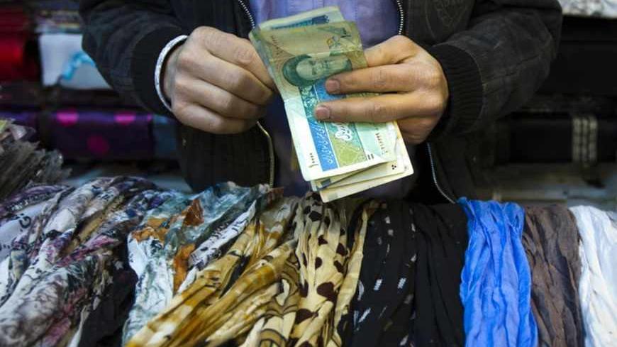 EDITORS' NOTE: Reuters and other foreign media are subject to Iranian restrictions on leaving the office to report, film or take pictures in Tehran.
A shopkeeper counts Iranian bank notes at his shop in a bazar in Tehran February 25, 2012. REUTERS/Raheb Homavandi (IRAN - Tags: SOCIETY BUSINESS) - RTR2YFBH
