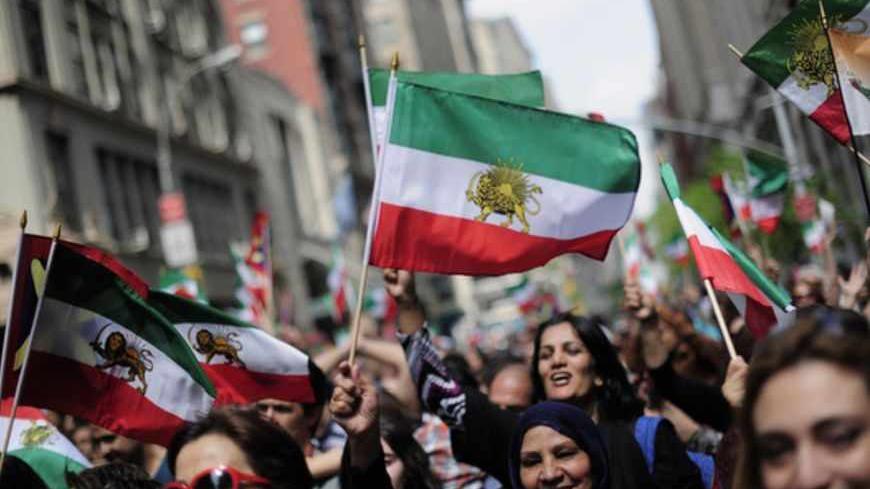 Marchers carry pre-Islamic Revolution flags of Iran as they march in the Persian Day Parade in New York, April 15, 2012. The parade is held in commemoration of Newroz, the Persian New Year. REUTERS/Keith Bedford (UNITED STATES - Tags: SOCIETY POLITICS) - RTR30SC6
