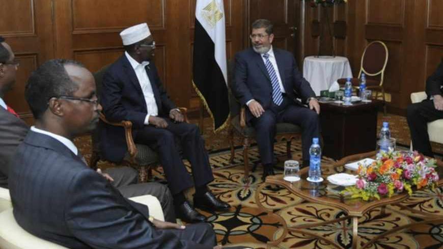 Egypt's President Mohamed Mursi (2nd R) meets with Somalia's President Sheikh Sharif Ahmed (3rd R) during the African Union (AU) leaders' meeting in Addis Ababa July 16, 2012. REUTERS/Mohamed Abd El Mouty/Egyptian Presidency/Handout (ETHIOPIA - Tags: POLITICS) FOR EDITORIAL USE ONLY. NOT FOR SALE FOR MARKETING OR ADVERTISING CAMPAIGNS. THIS IMAGE HAS BEEN SUPPLIED BY A THIRD PARTY. IT IS DISTRIBUTED, EXACTLY AS RECEIVED BY REUTERS, AS A SERVICE TO CLIENTS - RTR34ZTB