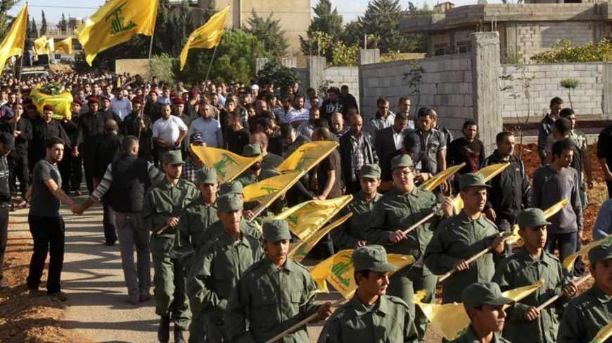 Lebanon's Hezbollah members carry the coffin of a Hezbollah member during his funeral in Ansar village near  Baalbek city October 8, 2012. Hezbollah gave no details about their deaths but sources in Baalbek said they and another Hezbollah man were killed near a Syrian border town where rebels are fighting Assad's forces. REUTERS/Ahmed Shalha (LEBANON - Tags: CIVIL UNREST POLITICS) - RTR38X92