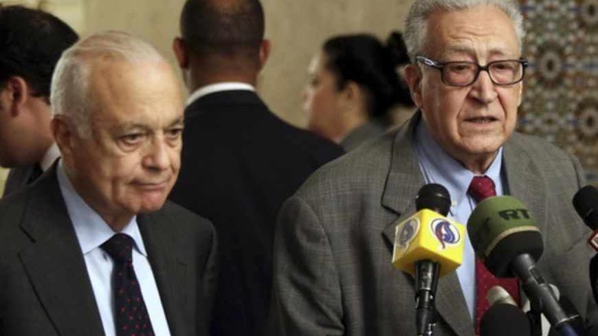 Arab League Secretary-General Nabil Elaraby (L) listens to U.N.-Arab League envoy for Syria Lakhdar Brahimi speak during a news conference at the Arab League headquarters in Cairo March 18, 2013. REUTERS/Stringer  (EGYPT - Tags: POLITICS) - RTR3F5HL