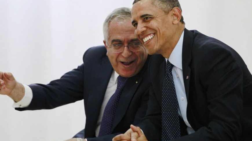 U.S. President Barack Obama (R) watches a cultural event alongside Palestinian Prime Minister Salam Fayyad at the Al Bireh Youth Center in Ramallah March 21, 2013.   REUTERS/Jason Reed   (WEST BANK - Tags: POLITICS) - RTR3F9QE