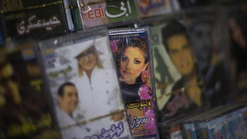 Pirated cassettes of Iranian singers are displayed for sale at a shop in Herat December 14, 2009. REUTERS/Morteza Nikoubazl (AFGHANISTAN - Tags: CRIME LAW MEDIA) - RTXRUNI