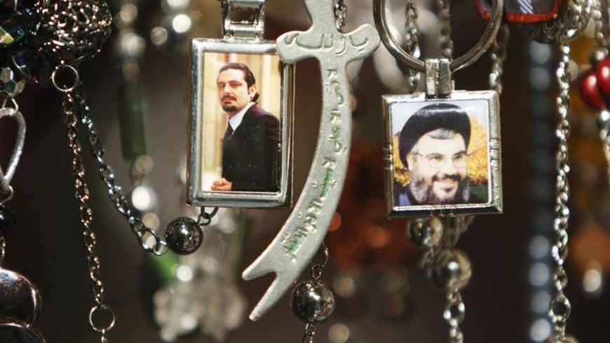 Pictures of Lebanon's Hezbollah leader Sayyed Hassan Nasrallah (R) and Lebanese caretaker Prime Minister Saad al-Hariri are seen on key rings at a gift shop in the port city of Sidon, southern Lebanon, January 19, 2011. Saudi Arabia has abandoned its mediation efforts in Lebanon, saying the situation was "dangerous," Al Arabiya television said on Wednesday, citing Foreign Minister Prince Saud al-Faisal. REUTERS/ Ali Hashisho   (LEBANON - Tags: POLITICS) - RTXWRZE
