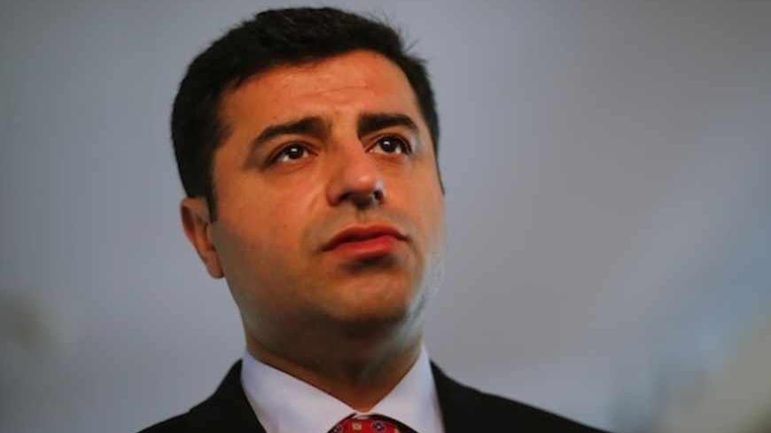 Selahattin Demirtas, co-chairman of the pro-Kurdish Peace and Democracy Party (BDP) answers a question during a Reuters interview in Berlin April 15, 2013. A top Kurdish politician said on Monday it would be difficult for Kurdish fighters to disarm before leaving Turkey under a peace process, stressing that the key issue was that they depart peacefully without contact with the Turkish military. Prime Minister Tayyip Erdogan's government is seeking a weapons-free pullout by militants of the Kurdistan Workers