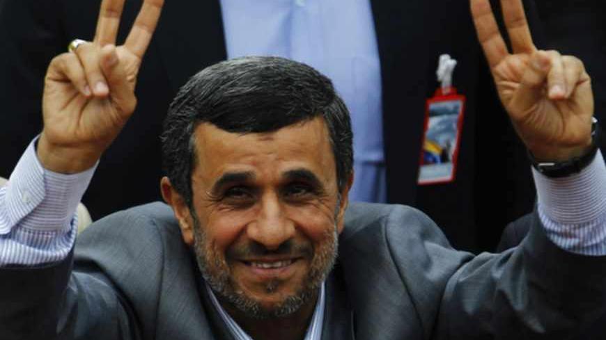 Iran's President Mahmoud Ahmadinejad gestures to supporters during a ceremony to swear Venezuela's President Nicolas Maduro (not pictured) into office, in Caracas April 19, 2013. Maduro was sworn in as Venezuela's president on Friday at a ceremony attended by several countries' leaders, after a decision to widen an electronic audit of the vote took some of the heat out of a dispute over his election. REUTERS/Carlos Garcia Rawlins (VENEZUELA - Tags: POLITICS ELECTIONS) - RTXYSQX