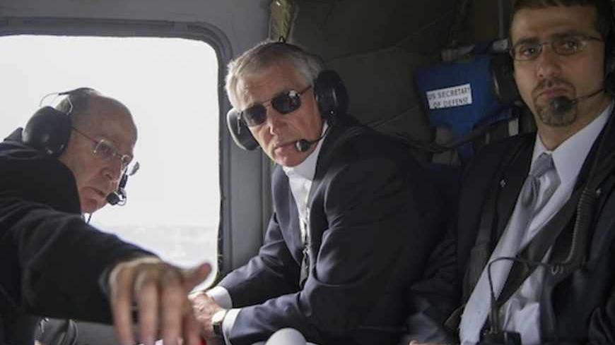 U.S. Defense Secretary Chuck Hagel (R) and his Israeli counterpart Moshe Yaalon (L) look out of the window during a helicopter tour of the Israeli-annexed Golan Heights April 22, 2013.  Israel suggested on Monday it would be patient before taking any military action against Iran's nuclear programme, saying during a visit by Hagel there was still time for other options.   REUTERS/Jim Watson/Pool (ISRAEL - Tags: POLITICS MILITARY TRAVEL) - RTXYVU8