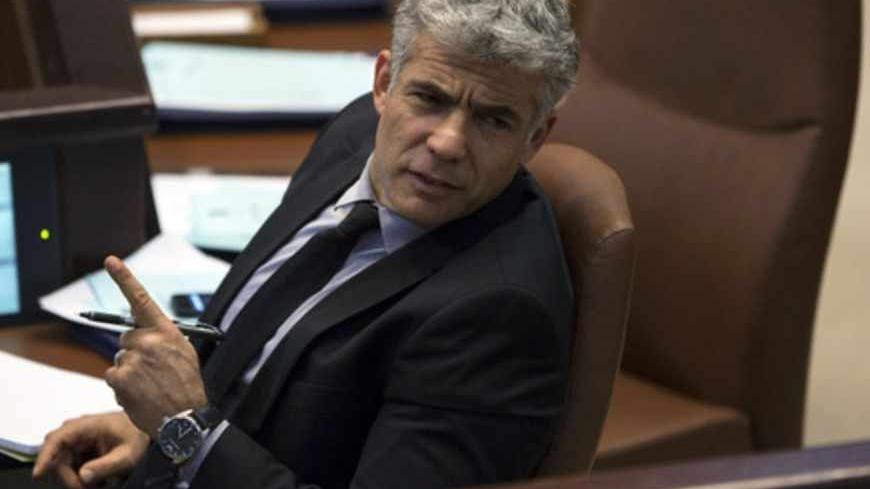 Israel's Finance Minister Yair Lapid gestures as he attends the opening of the summer session of the Knesset, the Israeli parliament, in Jerusalem April 22, 2013. Lapid is seeking spending cuts of 18 billion shekels ($5 billion) and tax increases of 5 billion shekels as part of the 2013-2014 budget framework, a spokeswoman for Lapid said on Monday. REUTERS/Baz Ratner (JERUSALEM - Tags: POLITICS BUSINESS) - RTXYVX6