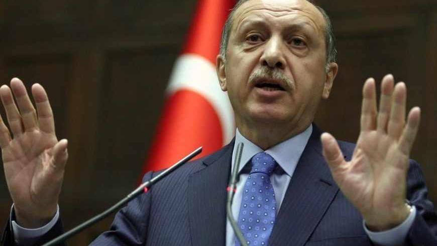 Turkey's Prime Minister Recep Tayyip Erdogan addresses his lawmakers in Ankara, on March 26, 2013. Erdogan said today that he planned to create a committee of "wise men" with an advisory role, to supervise the peace process currently underway with Kurdish rebels of the Kurdistan Workers Party (PKK). AFP PHOTO / ADEM ALTAN        (Photo credit should read ADEM ALTAN/AFP/Getty Images)