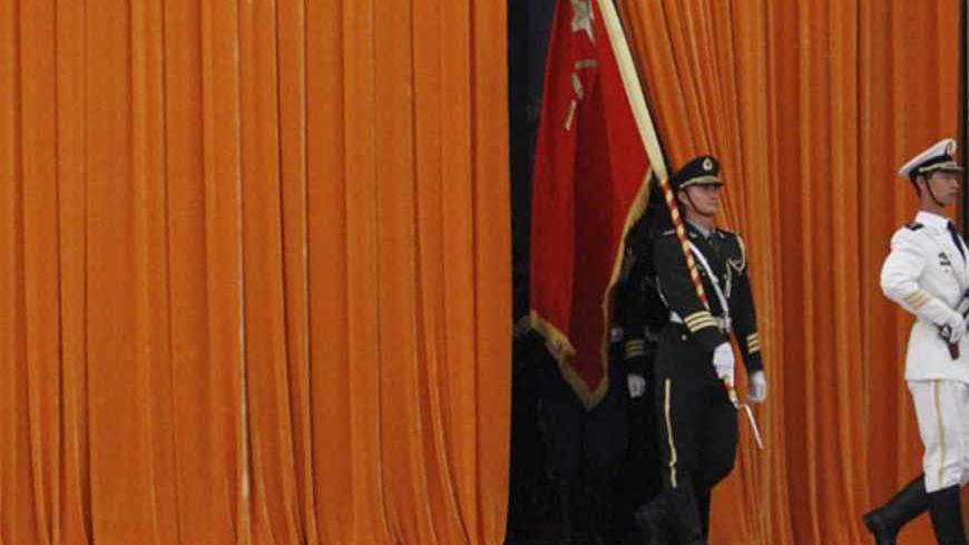 Honour guards walk out from behind a curtain, before the start of an official welcoming ceremony for the Shanghai Cooperation Organization (SCO) summit, at the Great Hall of the People in Beijing June 7, 2012. REUTERS/David Gray (CHINA - Tags: POLITICS) - RTR3382O
