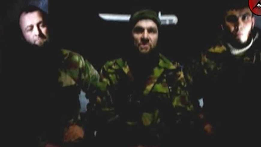 An undated still image taken from video shows the address of Chechen rebels, led by Emir of the Caucasus Doku Umarov (C). Chechen rebel leader Umarov has said his forces will carry out more attacks and that Russia faces a year of "blood and tears" if it refuses to abandon its North Caucasus territories, according to a story on February 5, 2011.  REUTERS/www.kavkazcenter.com/Reuters TV   (RUSSIA - Tags: CRIME LAW POLITICS CIVIL UNREST) - RTXXHY0
