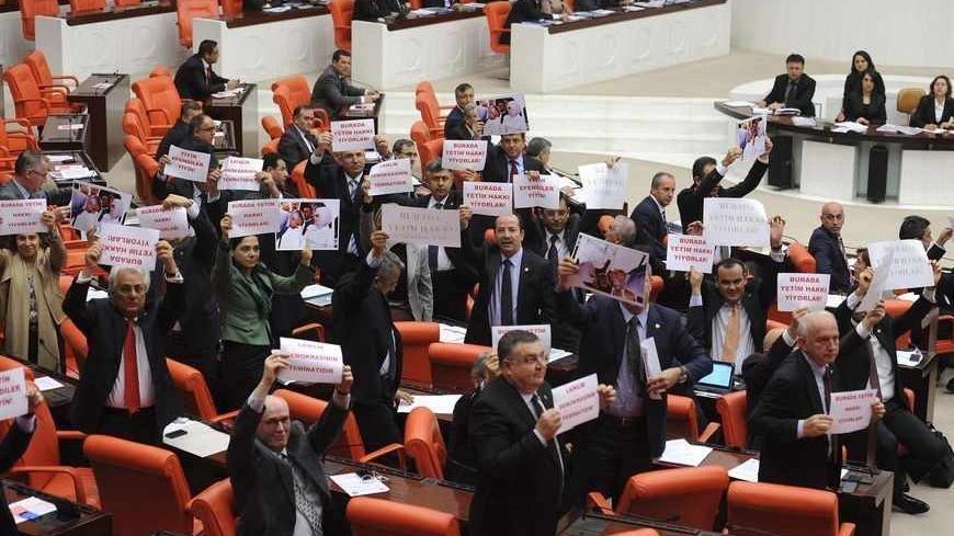 Members of Turkish parliament from the main opposition Republican People's Party (CHP) stage a protest during a debate at the parliament in Ankara March 30, 2012. Turkey's ruling party pushed through a school reform act on Friday that provoked brawls among parliamentarians and mass protests by secular Turks and teachers, who said the law was pushing an Islamic agenda and would lower education standards. Prime Minister Tayyip Erdogan sent shudders through the secular opposition earlier this year when he said