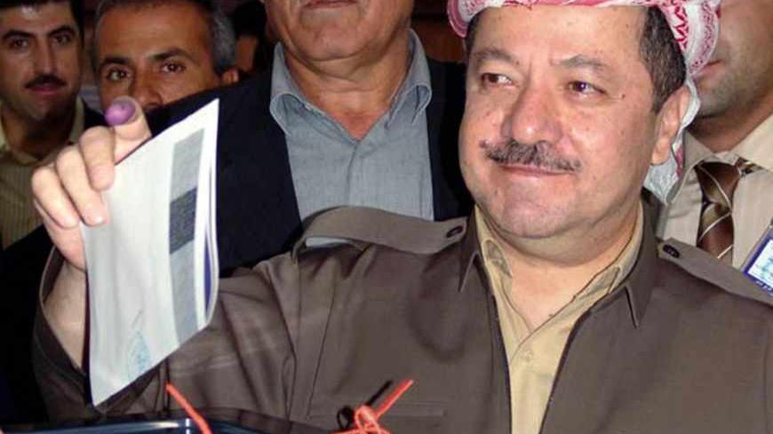 Kurdish leader Massoud Barzani votes in Iraq's constitutional referendum in the northern city of Arbil October 15, 2005. Iraqis headed to the polls in an historic referendum on Saturday, with up to 15 million eligible voters deciding on a controversial new post-Saddam Hussein constitution that its backers hope will unite the torn country. Amid intense security, including a ban on all traffic, voters flowed on foot to polling stations across Baghdad as they opened at 7 a.m. (0400 GMT). They are due to close 