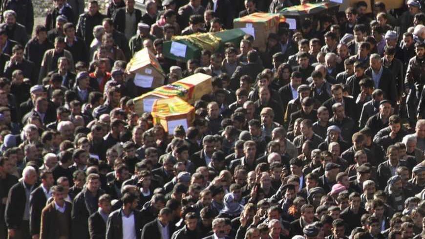Coffins of victims killed in air strikes are carried by villagers during a funeral ceremony in Gulyazi near the southeastern Turkish town of Uludere, in Sirnak province, December 30, 2011. Turkish rights groups called on Friday for a U.N.-sponsored investigation after Turkish warplanes killed 35 villagers in an airstrike targeting Kurdish rebels on the Iraqi border that the government has called an operational mistake. REUTERS/Stringer (TURKEY - Tags: POLITICS) - RTR2VQMI