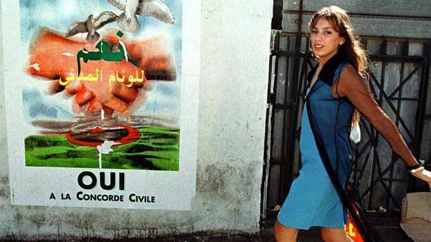 A young woman walks past posters for the referendum on "civil concord"
in Algiers, September 11, 1999. REUTERS/Zohra Bensemra

MDF197738.TIF - RTRR19H