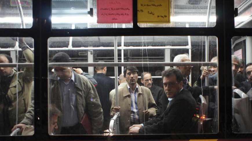 EDITORS' NOTE: Reuters and other foreign media are subject to Iranian restrictions on their ability to film or take pictures in Tehran.
An Iranian man looks on as he sits on a bus in Tehran December 22, 2010. With Iranians feeling choked by foreign sanctions, broken promises and money worries, President Mahmoud Ahmadinejad faces as much pressure on the economic front as from politics. Ahmadinejad has cut fuel and food subsidies to save $100 billion on the state budget and to make Iran less vulnerable to an