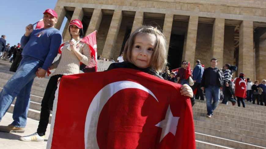 A girl holds a Turkish national flag as she visits the mausoleum of Mustafa Kemal Ataturk, founder of modern Turkey, during a ceremony to mark National Sovereignty and Child's Day in Ankara April 23, 2013. REUTERS/Umit Bektas (TURKEY - Tags: POLITICS) - RTXYWM1