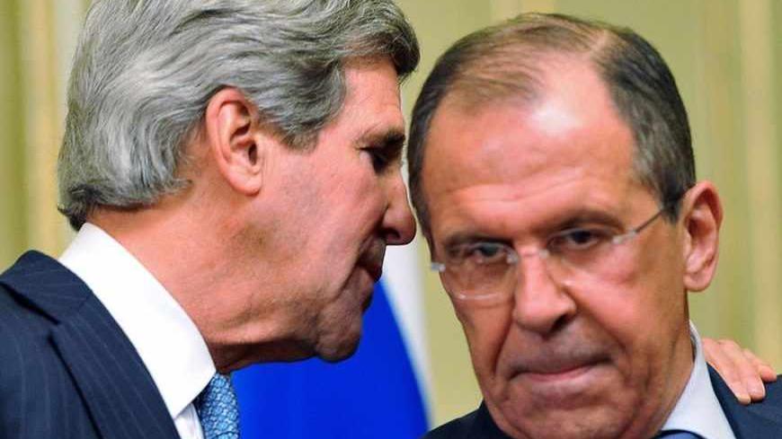 U.S. Secretary of State John Kerry (L) whispers to Russian Foreign Minister Sergei Lavrov during a joint news conference after their meeting in Moscow May 7, 2013. Russia and the United States agreed on Tuesday to try to arrange an international conference this month on ending the civil war in Syria, and said both sides in the conflict should take part. REUTERS/Mladen Antonov/Pool (RUSSIA - Tags: POLITICS CONFLICT) - RTXZE44