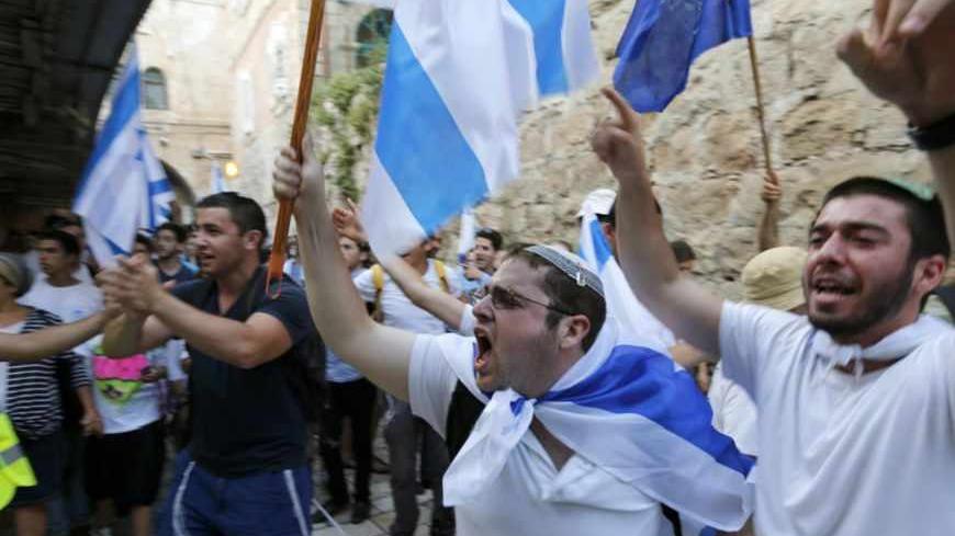 Israelis carry flags as they celebrate in Jerusalem's Old City during a parade marking Jerusalem Day May 8, 2013. Jerusalem Day marks the anniversary of Israel's capture of the Eastern part of the city during the 1967 Middle East War. In 1980, Israel's parliament passed a law declaring united Jerusalem as the national capital, a move never recognised internationally. REUTERS/Ronen Zvulun (JERUSALEM - Tags: POLITICS ANNIVERSARY) - RTXZF8V