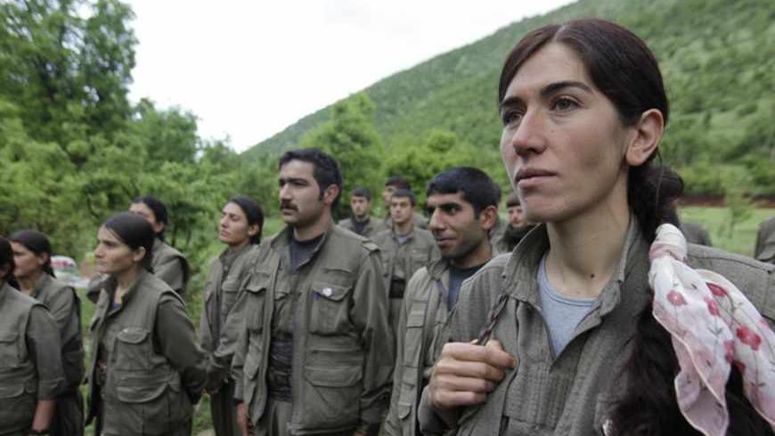 Kurdistan Workers Party (PKK) fighters stand at formation in northern Iraq May 14, 2013. The first group of Kurdish militants to withdraw from Turkey under a peace process entered northern Iraq on Tuesday, and were greeted by comrades from the Kurdistan Workers Party (PKK), in a symbolic step towards ending a three-decades-old insurgency. The 13 men and women, carrying guns and with rucksacks on their backs, arrived in the area of Heror, near Metina mountain on the Turkish-Iraqi border, a Reuters witness sa