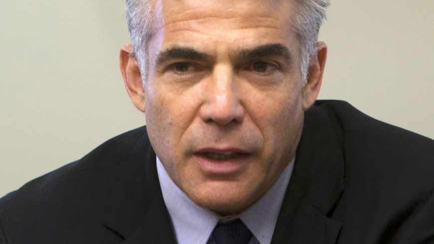 Israel's Finance Minister Yair Lapid attends a Yesh Atid party meeting at the Knesset, the Israeli parliament, in Jerusalem May 20, 2013. Lapid, whose new centrist party is the second largest in Israel's government, said on Monday thousands of Jewish settlers would have to be removed from occupied land under any peace deal with the Palestinians. REUTERS/Ronen Zvulun (JERUSALEM - Tags: POLITICS HEADSHOT) - RTXZTWT