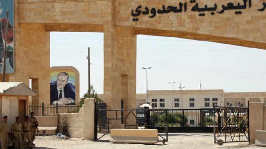 A general view shot on July 23, 2012 shows portraits of Syrian President Bashar al-Assad (L) and his late father and predecessor, Hafez al-Assad (back), at the al-Yaroubiya border crossing between Syria and Iraq, close the northern Iraqi city of Mosul. Syrian citizens are fleeing to neighboring countries including Iraq,  Lebanon and Turkey as fighting between Syrian government forces and Free Syria Army rebels intensifies. AFP PHOTO/STR        (Photo credit should read -/AFP/GettyImages)