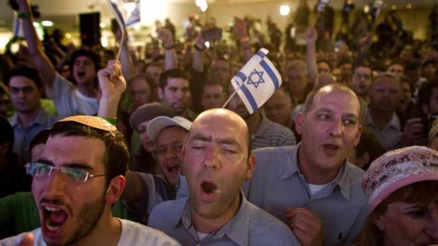 RAMAT GAN, ISRAEL - JANUARY 22:  (ISRAEL OUT) Supporters and activists of the Habayit Hayehudi party (The Jewish Home) react to the announcement of the first projections on the results of Israel's national elections at a post-election rally on January 22, 2013 in Ramat Gan, Israel.  Polls are predicting 12 seats of 120 in the Israeli parliament for the right-wing, religious party led by Naftali Bennett, with Israel seeing the highest turnout of voters since 1999.  (Photo by Oren Ziv/Getty Images)