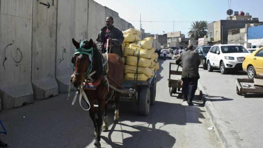 BAGHDAD, IRAQ - MARCH 13:  A horse and cart make their way through the Bab al Sharji market, March 13, 2013 in Baghdad, Iraq.  Ten years after the regime of Saddam Hussein was toppled from power, Baghdad continues to show the scars of the war. In vast areas, infrastructure is fractured and basic services are lacking, however, some areas of the capital are showing promising signs of recovery.   (Photo by Ali Arkady/Metrography/Getty Images)