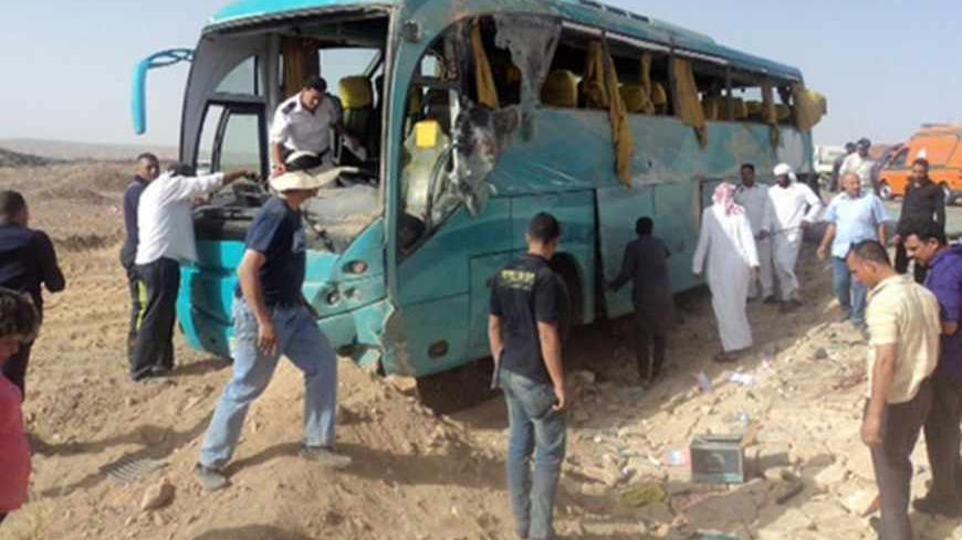 Egyptian security forces and emergency personnel inspect the bus at the site of a road accident in Egypt's Sinai Peninsula on May 31, 2013 which left four Mexican tourists killed. Seventeen tourists, all Mexican, were injured in the crash, South Sinai's governor told AFP, adding that two were in critical condition. AFP PHOTO/STR        (Photo credit should read -/AFP/Getty Images)
